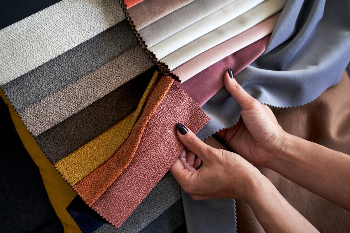 A woman's hand holding colorful fabric swatches