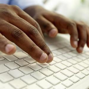 hands typing on a keyboard