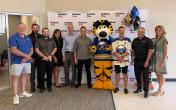 People standing together with Sabres mascot