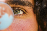person looking at a globe