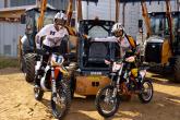 Two people on motorbikes fist bumping 
