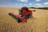 Red farm machine in a golden field