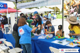 Kids and adults doing activities at an event table
