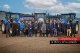 People standing together in front of blue machinery