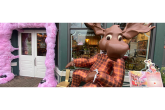A giant chocolate moose "sitting" in front of a store