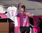 Man holding t-shirt jersey with #1 and Top Fundraiser on back.