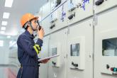 Facility worker in PPE speaking into a radio