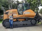 A person leaning against agricultural machinery 