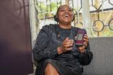 Woman laughing and pointing to smart phone