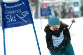 Person skiing next to a "celebrity ski" banner