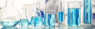 series of measuring glasses with light blue liquid