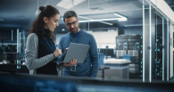 Two people looking at a laptop