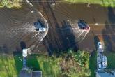 Aerial view of cars driving through a flooded street