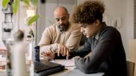 Parent and teenager looking at homework together