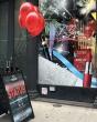 MAC store front with a "Know your status" board with red balloons in front.
