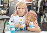 Two children at the Night of Baseball holding Aflac Ducks.
