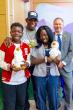 Deion Sanders shown with young patients holding the Aflac Duck.