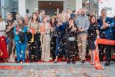 group photo behind ribbon