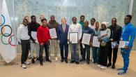 A group of people stood in a line holding awards