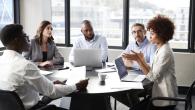 employees sitting around round table 