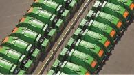 aerial view of two rows of green garbage trucks