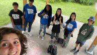 teens in Youth Central t-shirts and the photographer smiling in the foreground