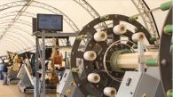 Workers produce the company's innovative liner product at a Smartpipe mobile factory.