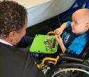 Aflac volunteers helping Dewey pick out even more beads to add to his collection.