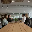 People sitting together and smiling at a conference table