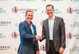 William R. Groves, J.D., chancellor of Antioch University, and John Comerford, Ph.D., president of Otterbein University, shake hands after the historic announcement of their institutions' intention to affiliate with each other to create a unique, national, nonprofit university system focused on educating students both for careers and to prepare students to advance social justice, democracy, and the common good.