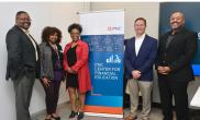 A small group of people stood either side of a PNC Center for Financial Education event banner