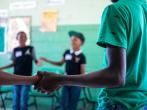 students holding hands in a circle