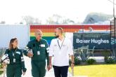 Three employees walking together outside