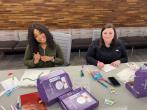 2 people at a table making cards