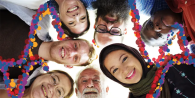 diverse group of people, standing close together and smiling