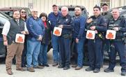 Group of first responders holding defibrillators 