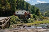 Photo of a house on a riverbank.