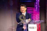 Man accepting award on stage