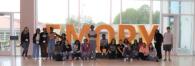 Group together in front of EMORY letters in window