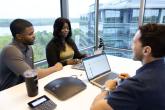 employees collaborating by windows