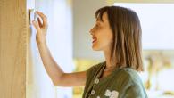 Woman adjusting thermostat