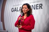 Person holding an award and giving a speech at the Global Cyber Conference 