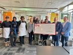 Representatives from KeyBank and Foodlink shown with a $300,000 grant check.