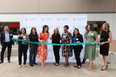 A group of people cutting a ribbon