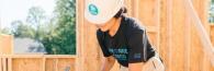 person wearing a hard hat building a structure