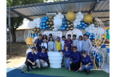 Group of children in front of a balloon arch