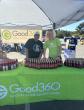 Two people standing at the Good360 booth