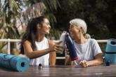 Two women drinking water after yoga.
