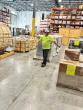 Worker in a Wesco warehouse preparing supplies for Hurricane Melissa relief.
