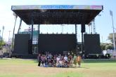 Students and event staff gather in front of the Head in the Clouds main stage during a behind-the-scenes venue tour.